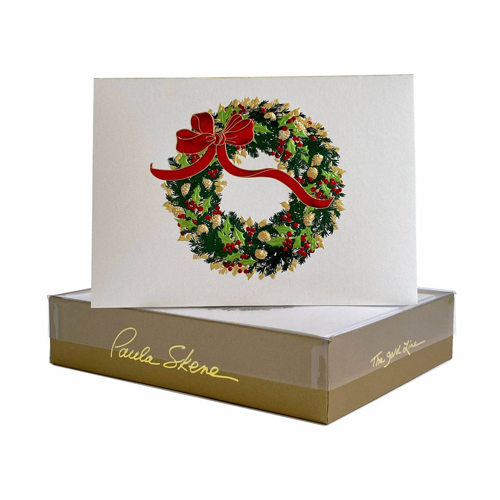 Christmas card with wreath design and red bow in a branded box