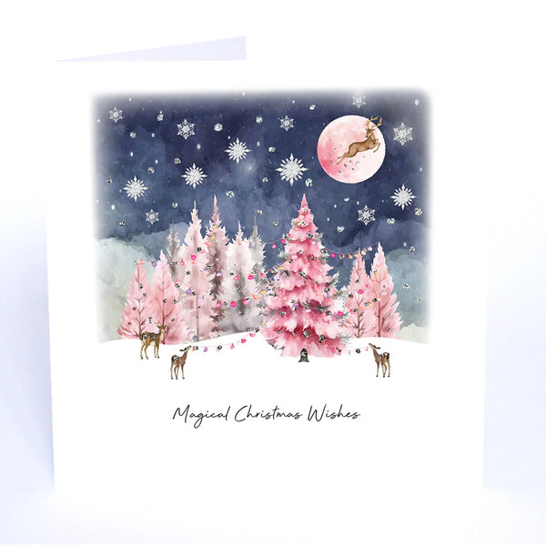 Christmas card with pink trees, deer, and a moonlit sky.