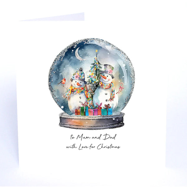 Christmas-themed snow globe with two snowmen, a tree, and presents on a white card.