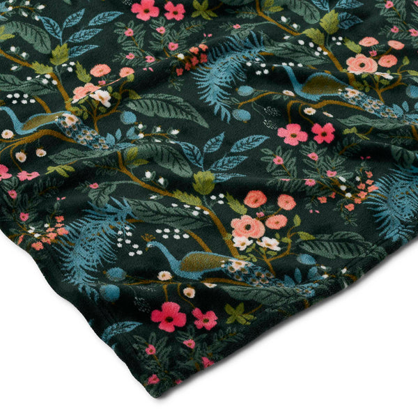 Floral and dragon patterned fabric on a dark background