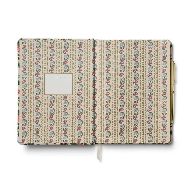 Patterned notebook with a gold clip on a white background