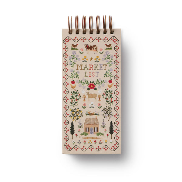 Notebook with decorative cover featuring illustrations and the text 'Market List' on a white background