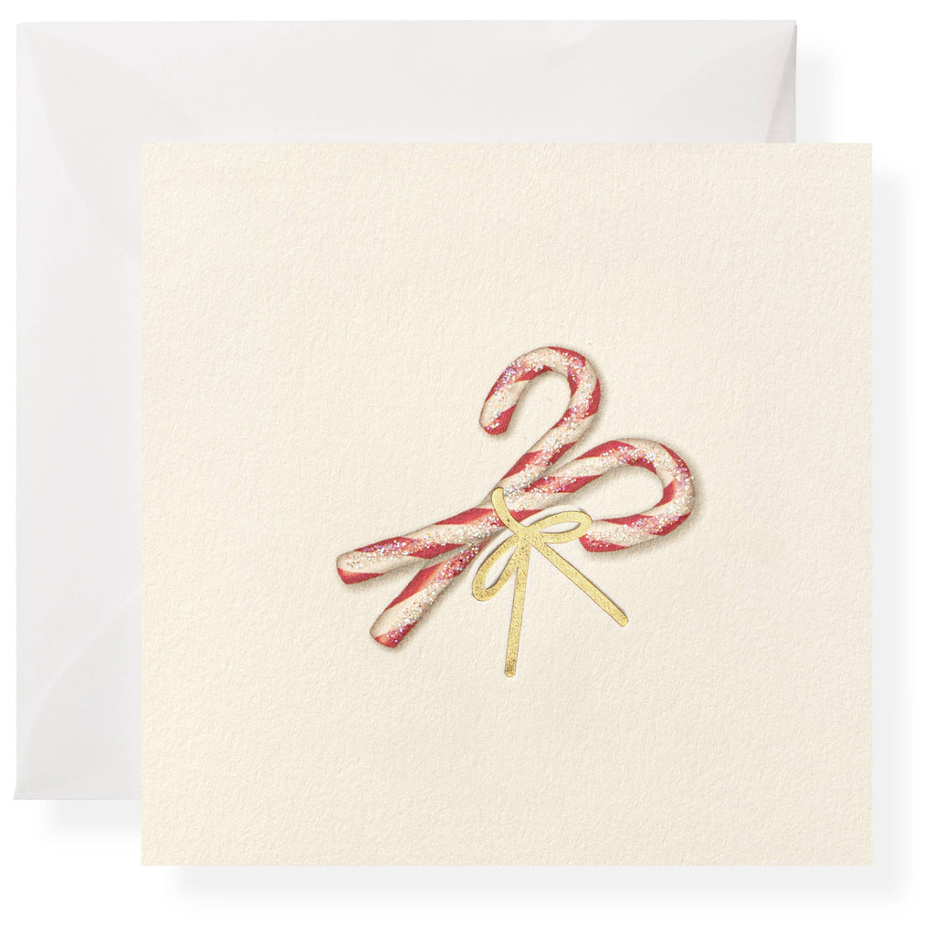 Greeting card with candy canes and a bow on a white background