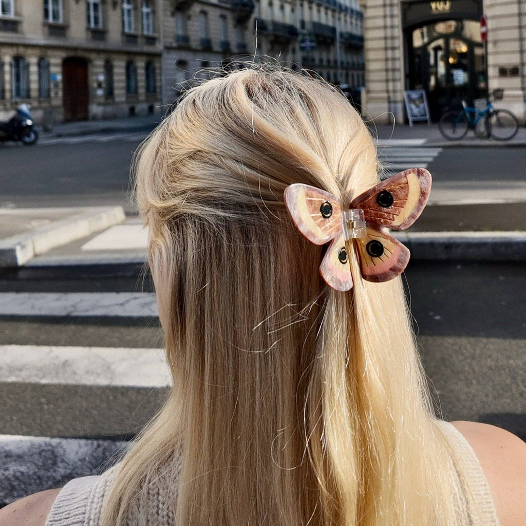 Person with a decorative hair clip in an urban setting
