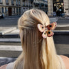 Person with a decorative hair clip in an urban setting