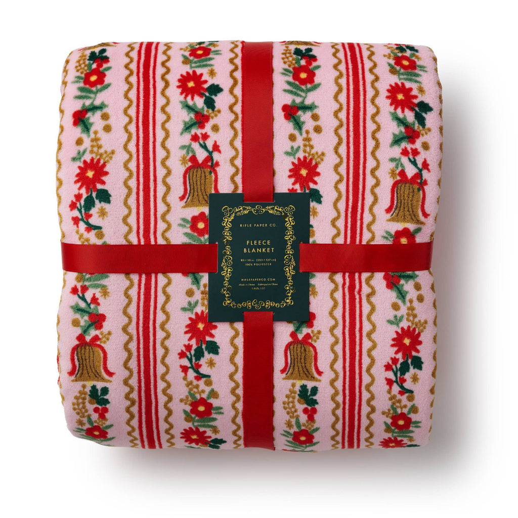 Floral and striped blanket with a brand label on a white background