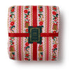 Floral and striped blanket with a brand label on a white background