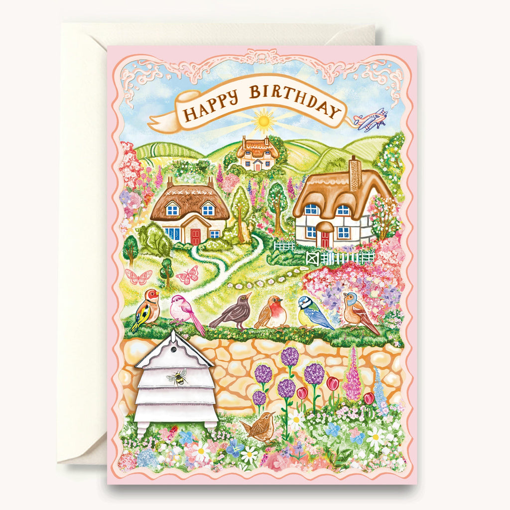 Birthday card with a scenic illustration of cottages, flowers, and birds on a white background.