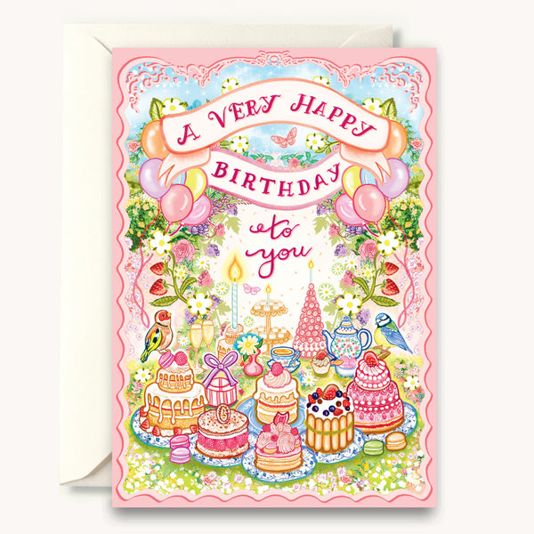 Birthday card with colorful illustrations of cakes, balloons, and flowers on a pink background.