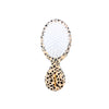 Hairbrush with leopard print handle on a white background