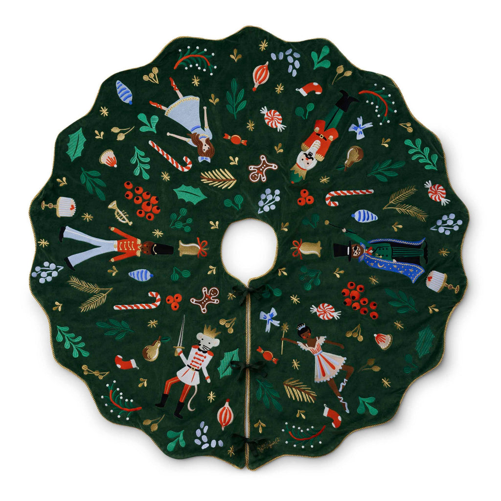 Decorative Christmas tree skirt with colorful designs on a white background
