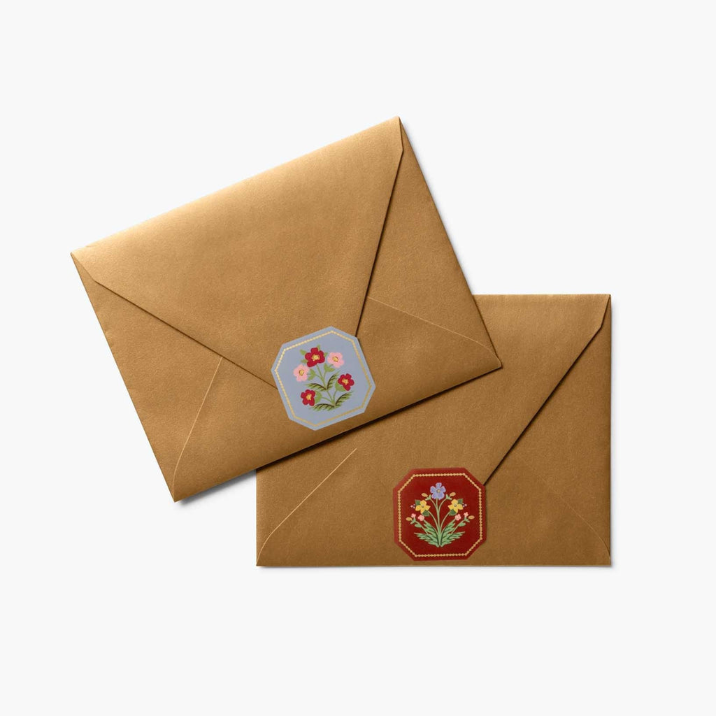 Two brown envelopes with floral designs on a white background