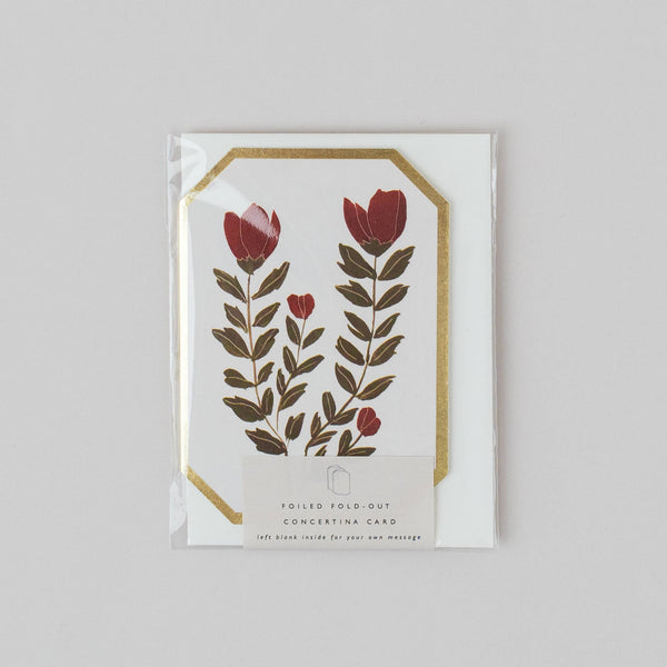 Floral design card with red flowers and green leaves on a white background