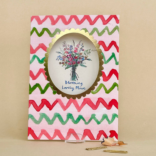 Greeting card with colorful zigzag pattern and floral illustration on a beige background