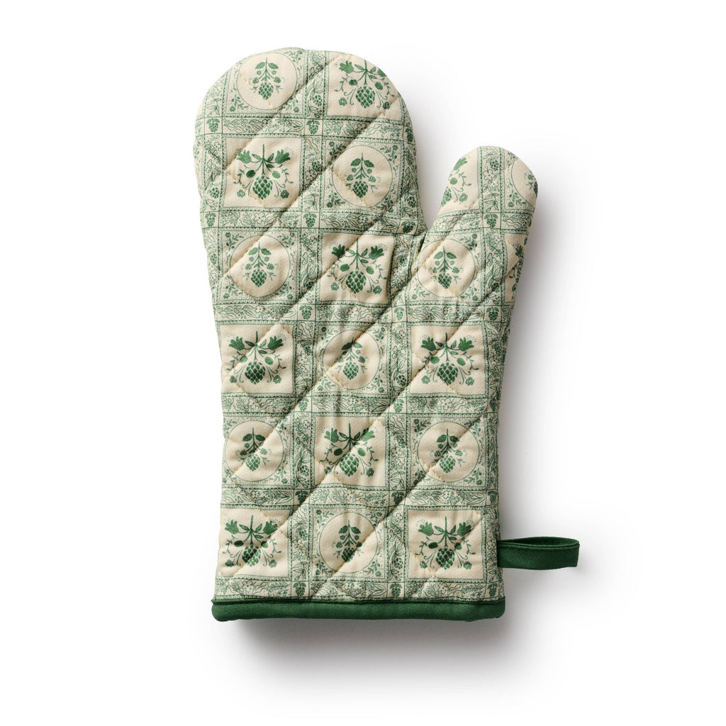 Green patterned oven mitt and pot holder on a white background