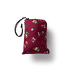 Red drawstring bag with floral patterns on a white background