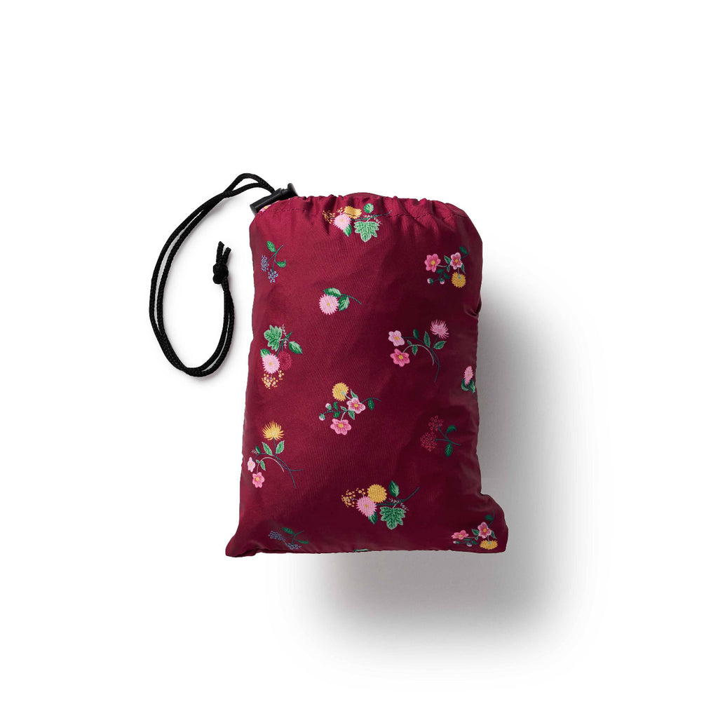 Red drawstring bag with floral patterns on a white background