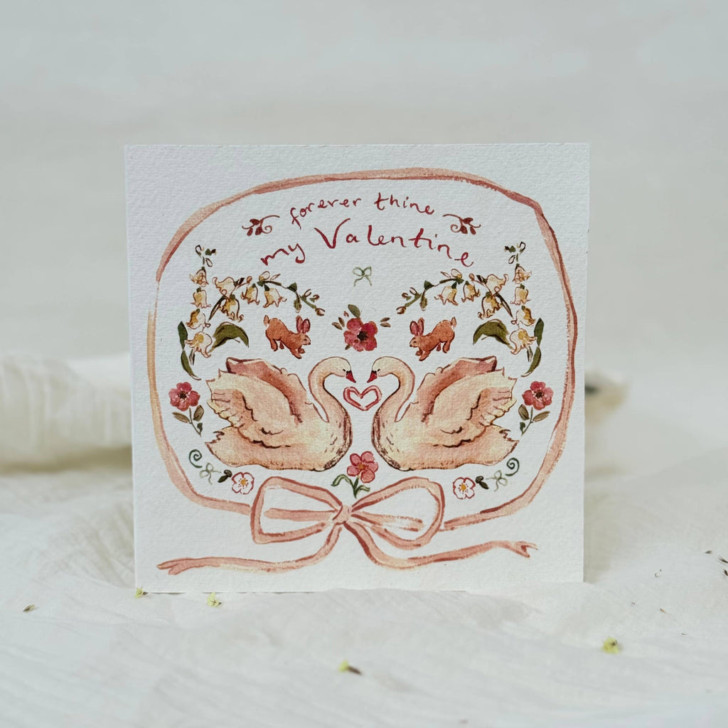 Valentine's Day card with swans and floral design on a white background