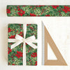 Christmas-themed wrapping paper with a gift and ruler on a white background