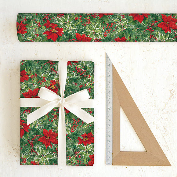 Christmas-themed wrapping paper with a gift and ruler on a white background
