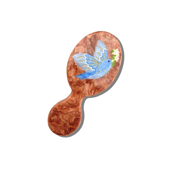 Wooden hairbrush with a butterfly design on a white background