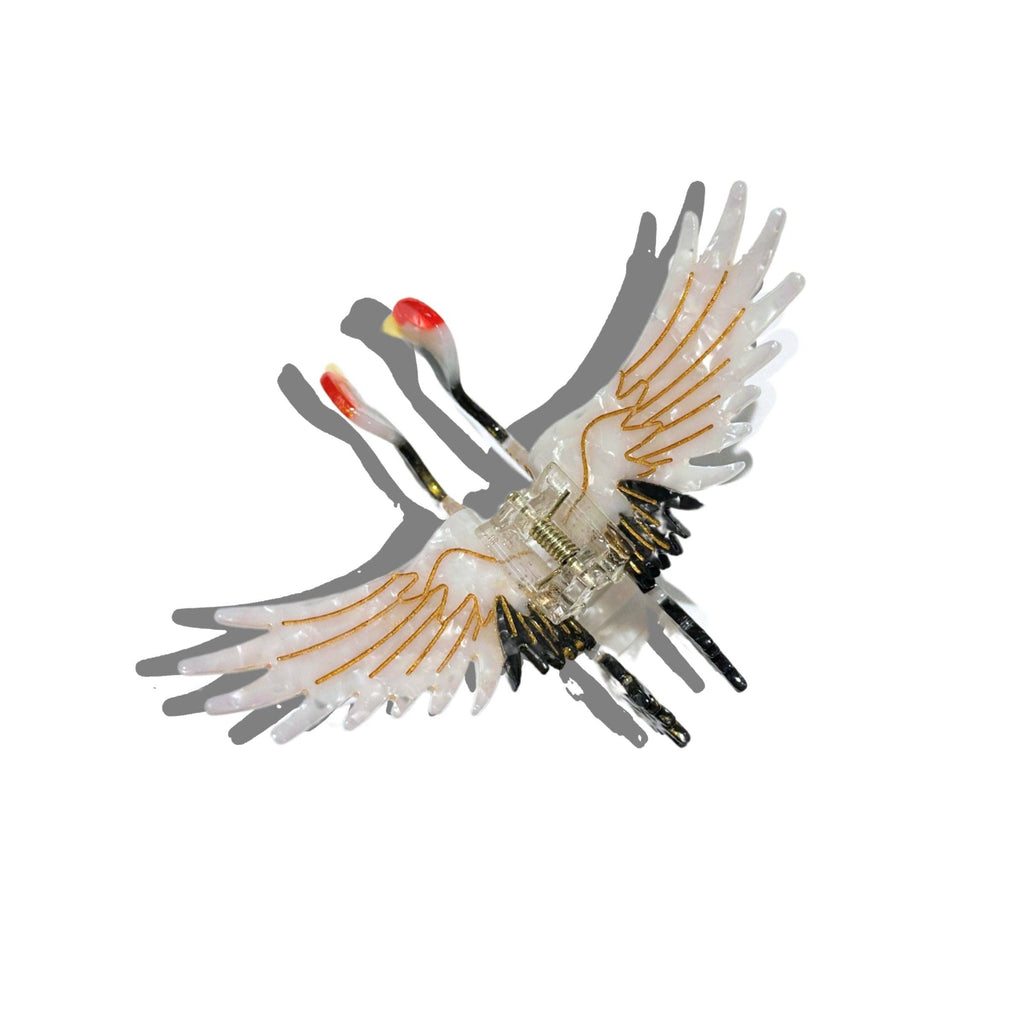 Toy bird with transparent body and colorful wings on a white background