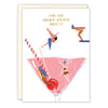 Birthday card with illustration of people in swimsuits in a pink cocktail, text 'Make your birthday hangover worth it!'.