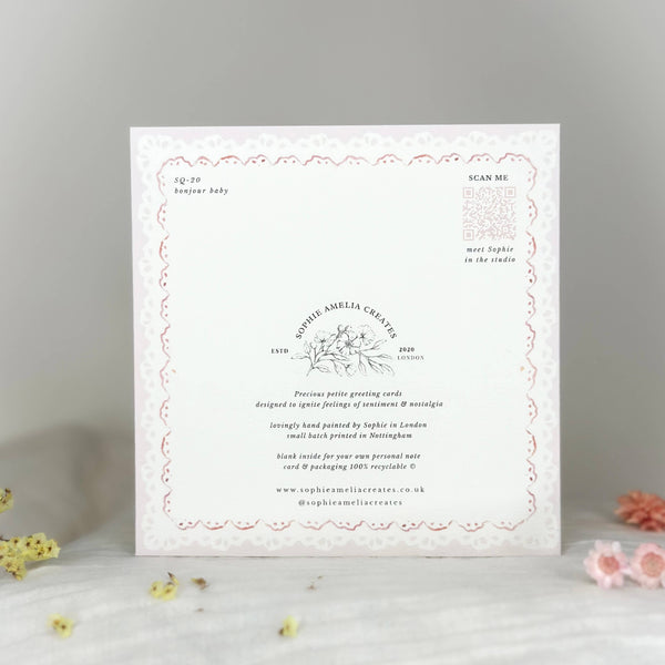 White card with text and decorative elements on a gray background