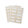 Sheet of white labels with gold borders on a white background