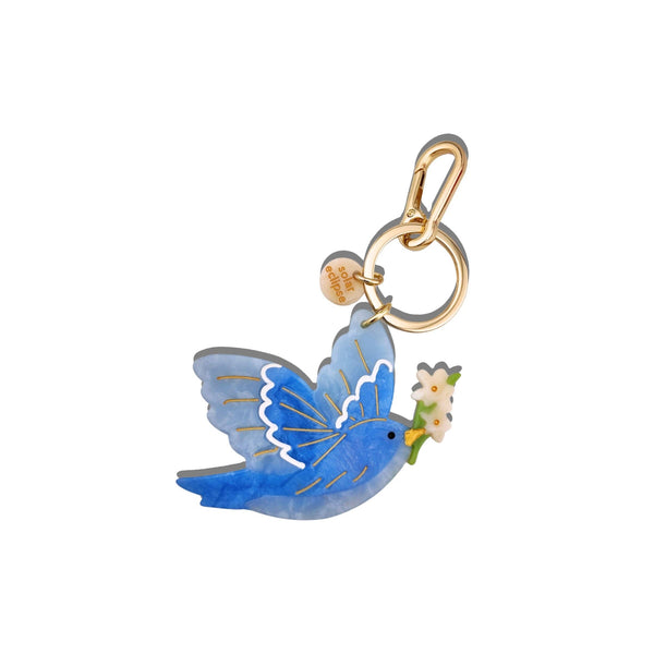 Blue butterfly charm with a gold ring on a white background
