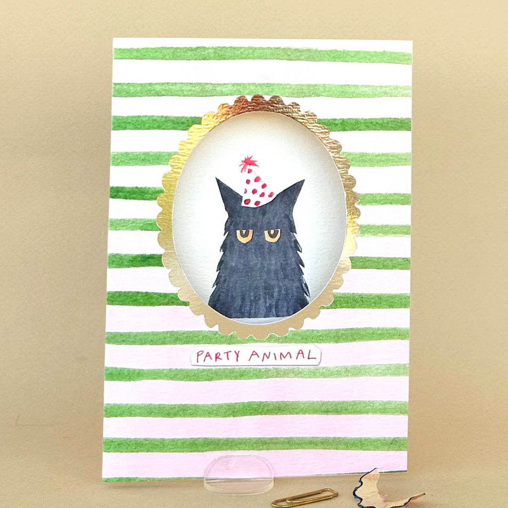Card with a cat wearing a party hat on a striped background