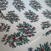 Christmas-themed paper with holly design on a white background