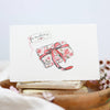 Card with floral design and ribbon on a white background