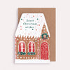 Greeting card with a gingerbread house design and 'Sweet Christmas wishes' text on a brown envelope.