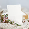 White card with floral design on a textured surface