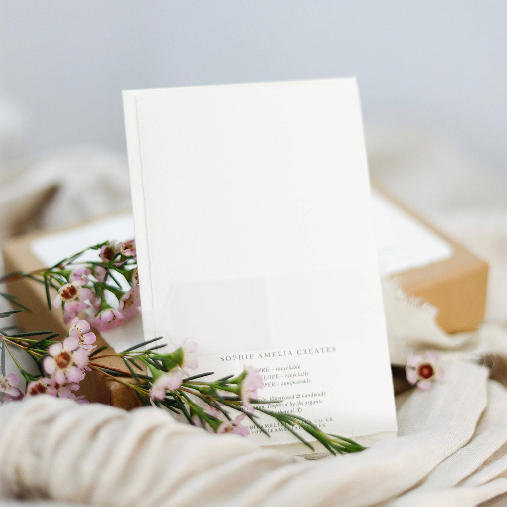 White card with floral design on a textured surface