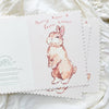 Card with a bunny illustration and text on a white textured background