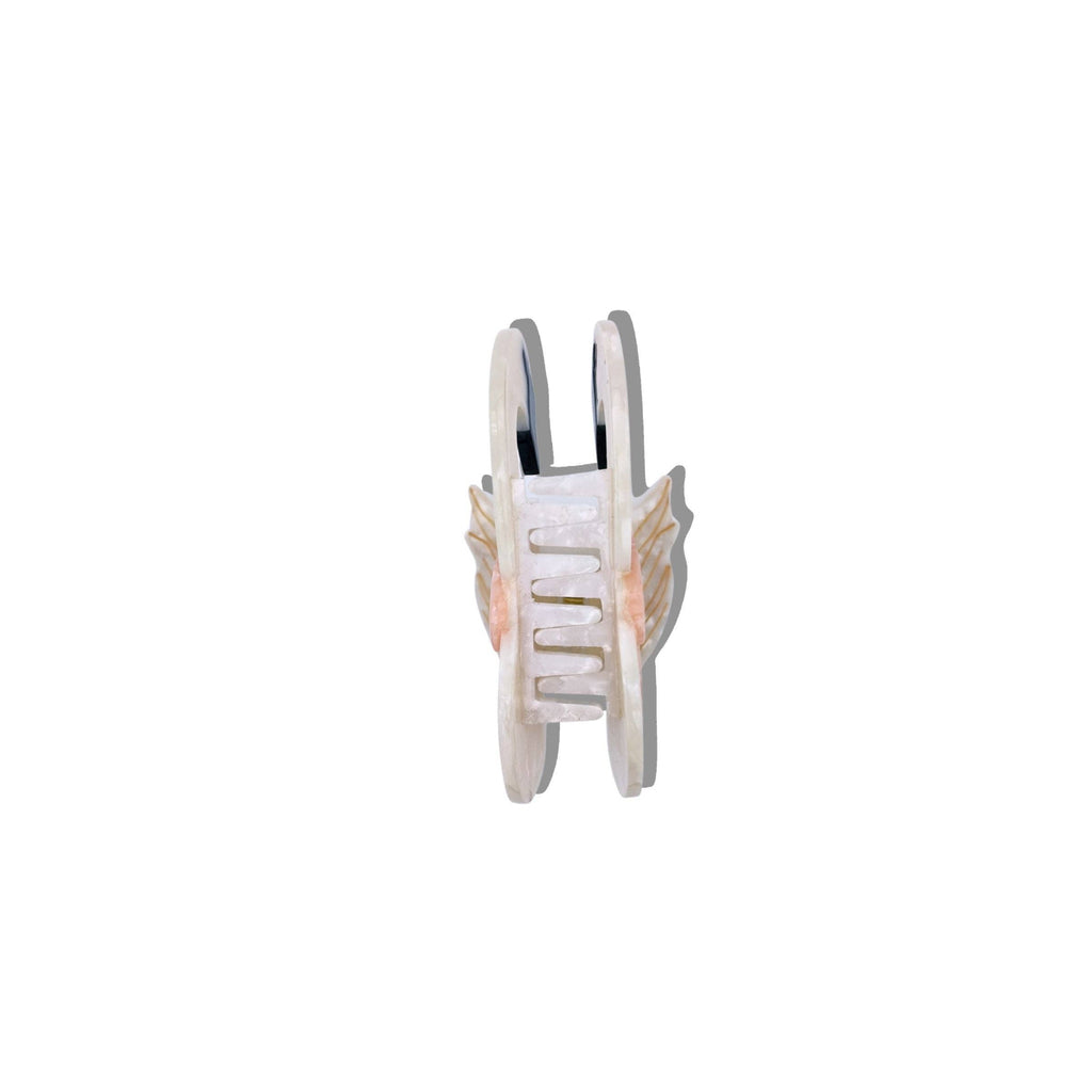 Small white toy with wings on a white background