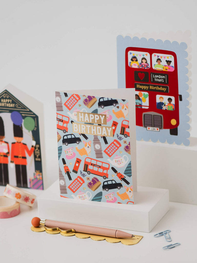 Collection of birthday cards with London-themed designs on a white surface.