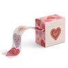 Box of heart-shaped envelope seals with a ribbon on a white background