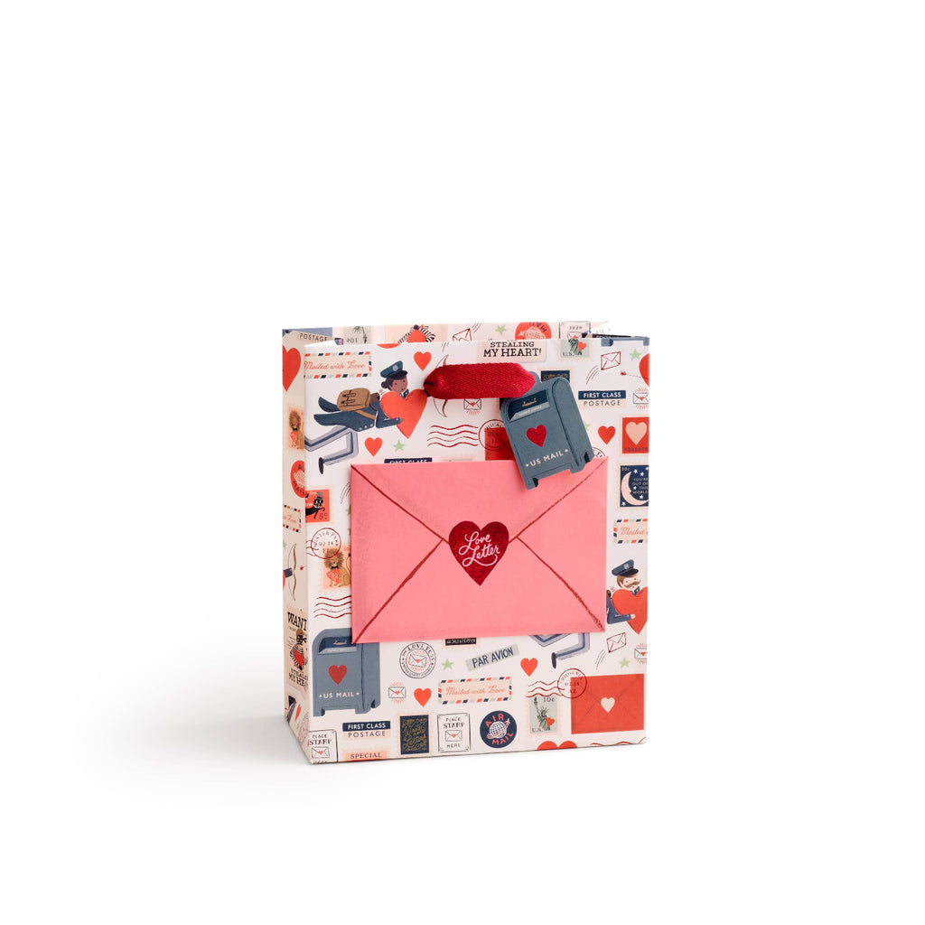 Gift bag with stationery-themed design on a white background