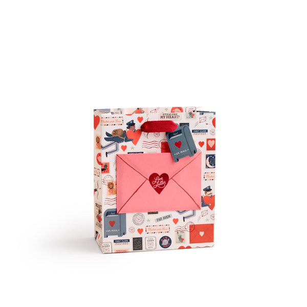 Gift bag with stationery-themed design on a white background