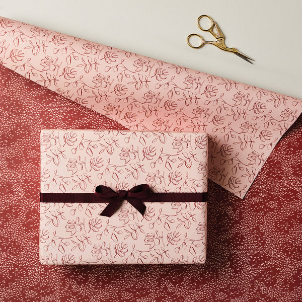 Gift box with floral pattern and ribbon on a matching fabric background