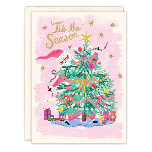 Christmas card with a decorated tree, presents, and 'Tis the Season text on a pink background.