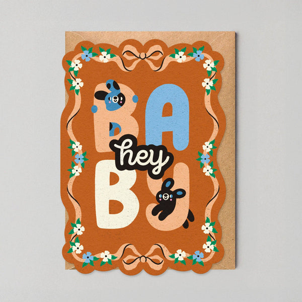 Card with 'hey baby' text and decorative elements on a gray background
