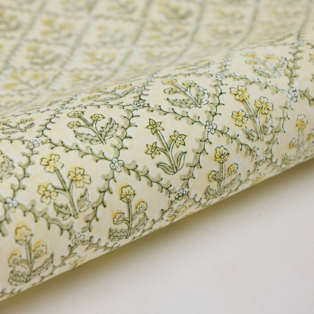 Roll of fabric with floral pattern on a white background