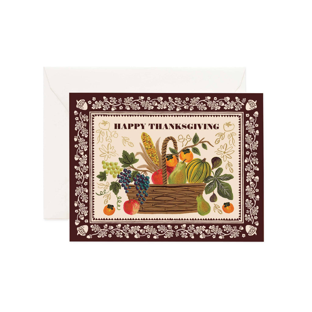 Thanksgiving card with a basket of fruits and vegetables and 'Happy Thanksgiving' text on a decorative border.