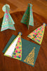 Colorful paper Christmas trees on a wooden surface