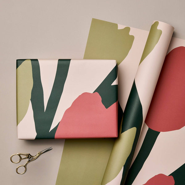 Gift box with floral pattern and scissors on a matching fabric background