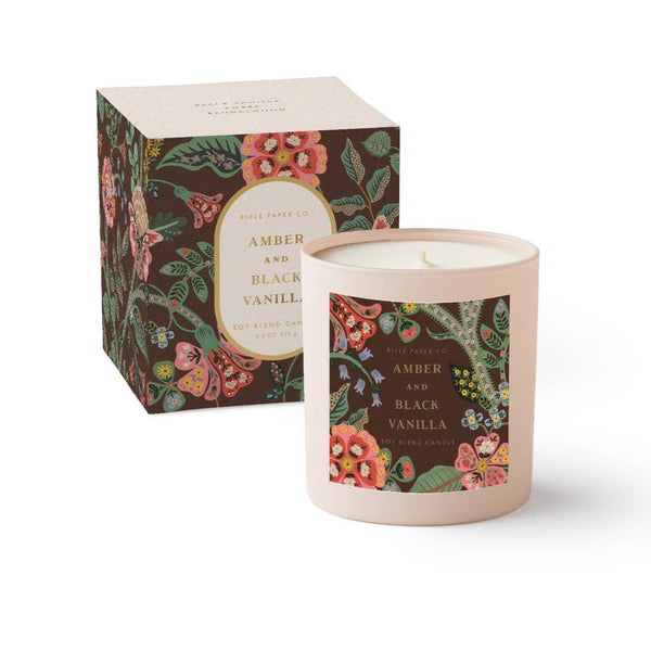 Candle with floral packaging and label on a white background